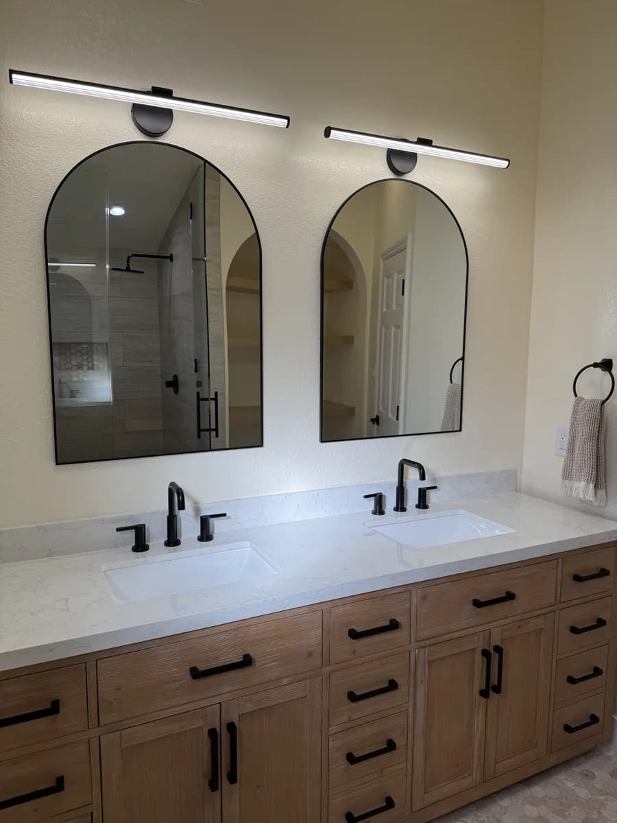 Master bathroom renovation with floating dual vanity, large-format tile, and frameless glass shower in Camarillo, CA