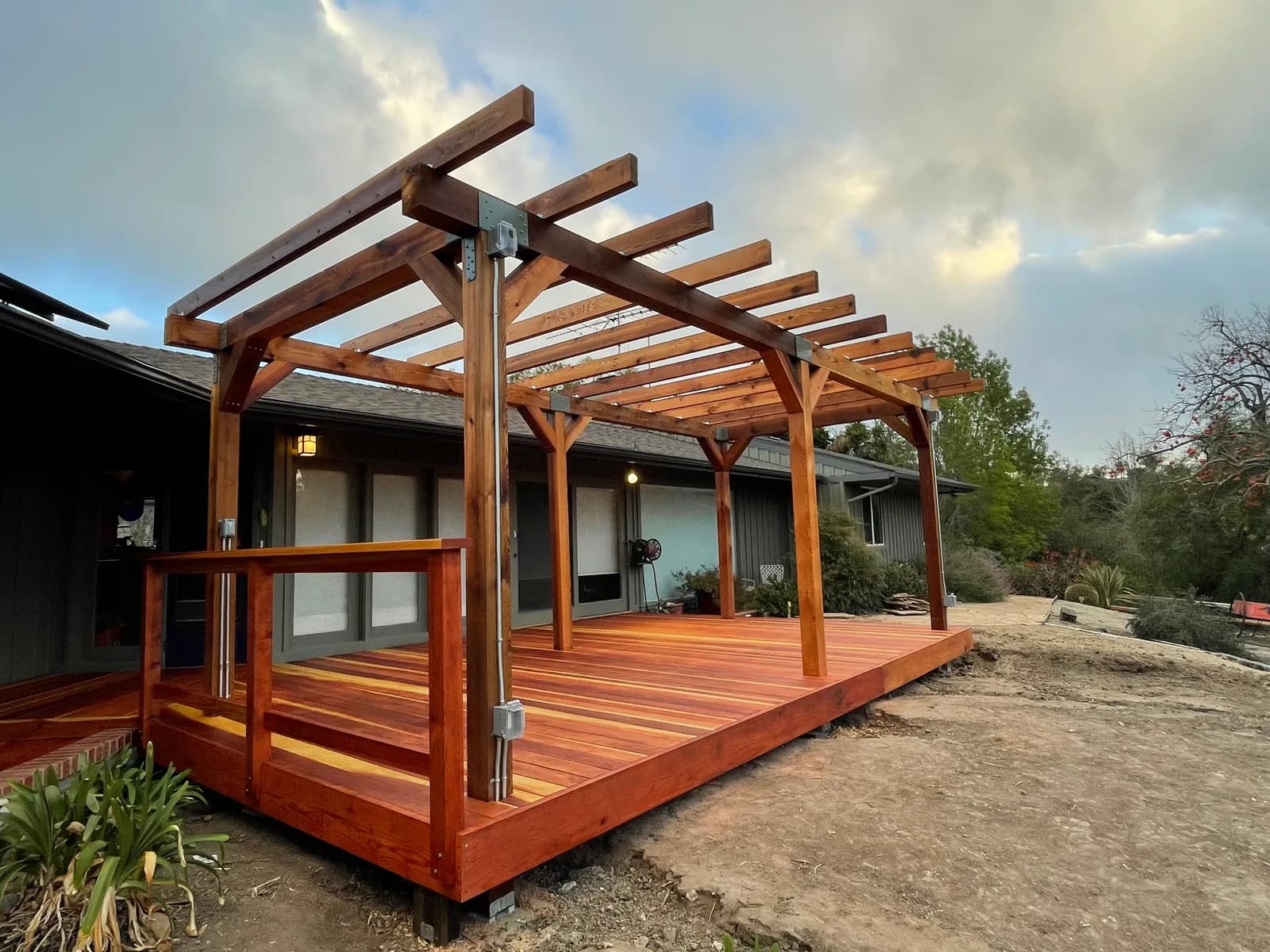 Outdoor cedar pergola over redwood deck with steel hardware and integrated lighting in Ventura County, CA