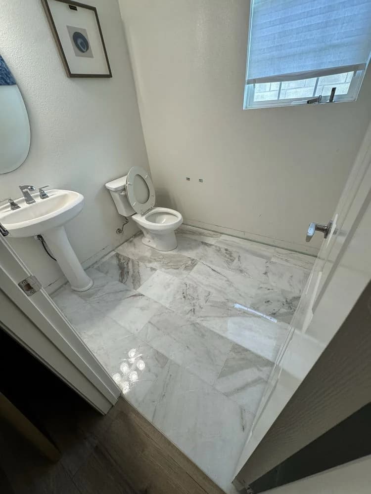 Powder room with custom marble tile floor and feature wall in Camarillo, CA