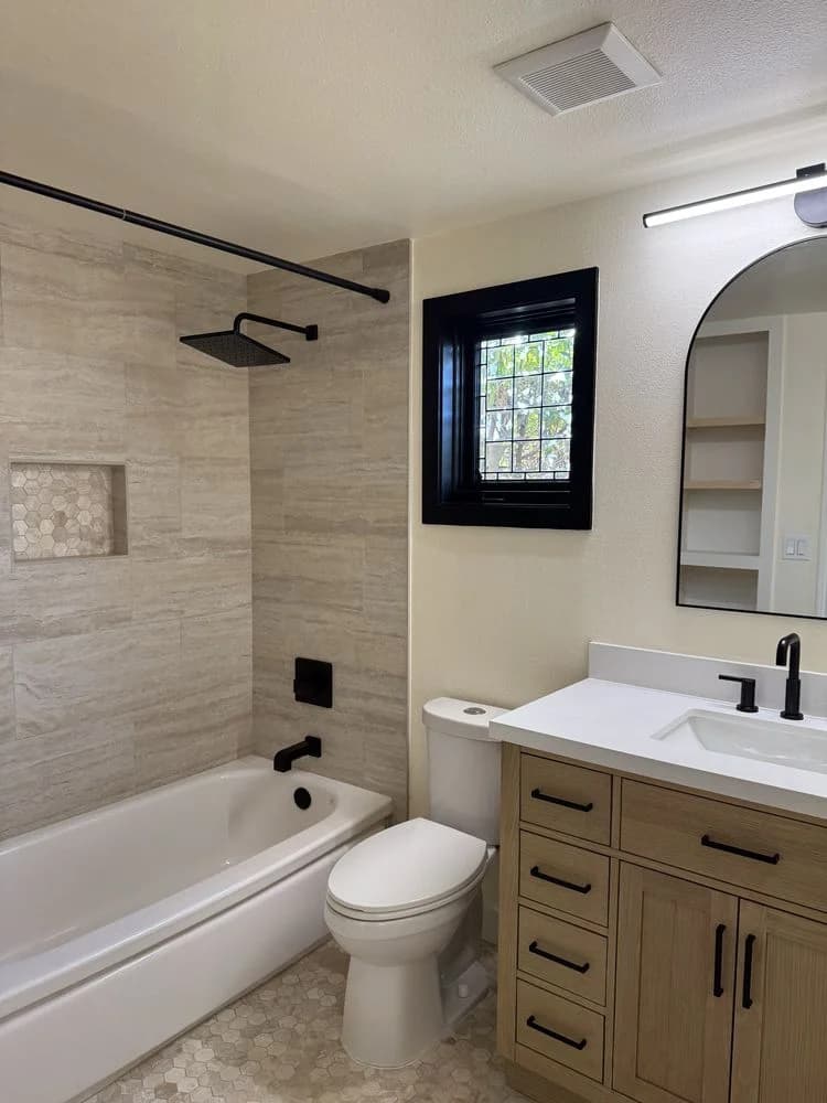 Bathroom remodel with walk-in tile shower, custom vanity, and updated plumbing fixtures in Camarillo, CA