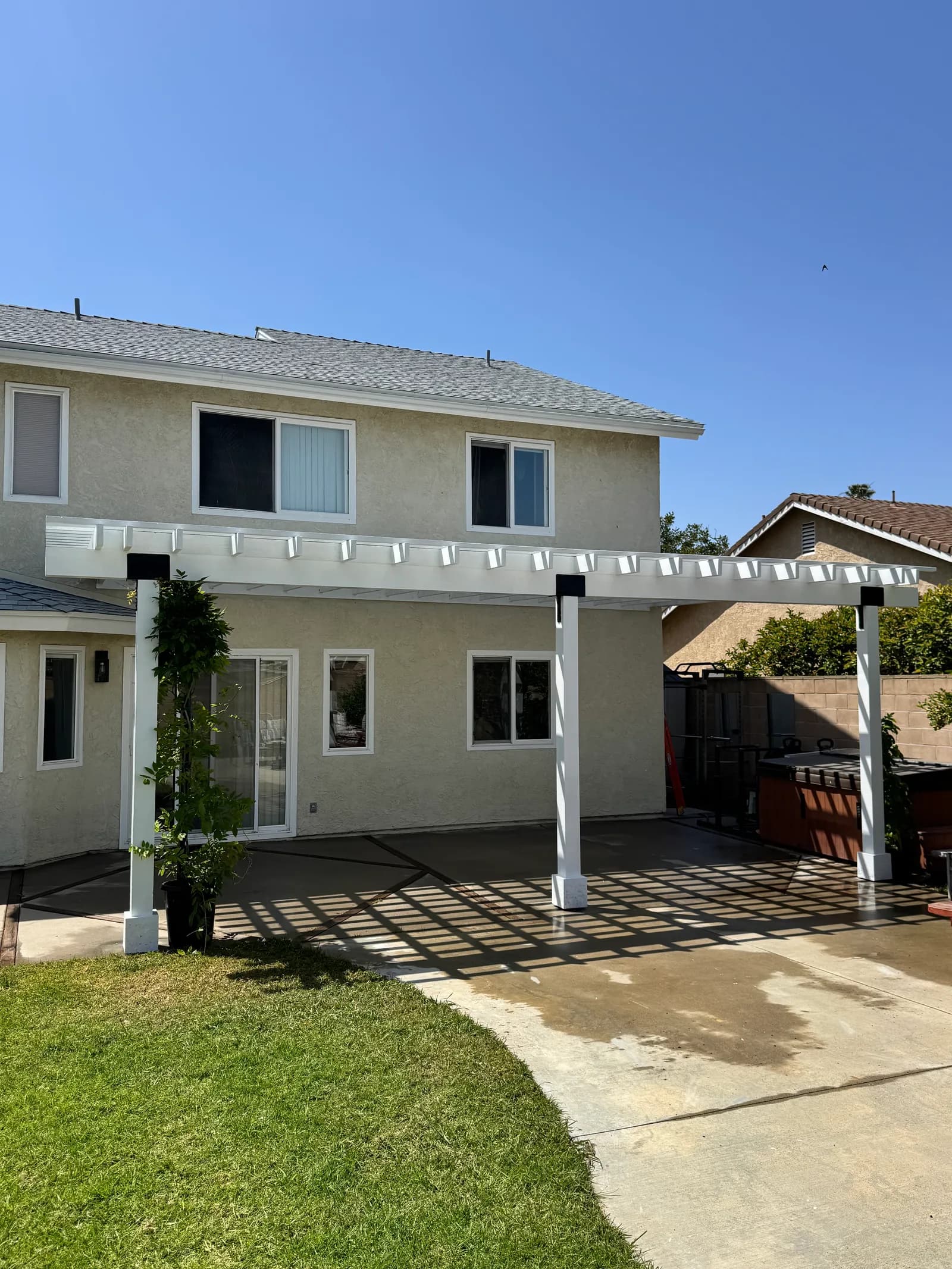 Custom cedar pergola and covered patio with structural beams and outdoor lighting in Oxnard, CA
